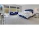Comfortable main bedroom with a large bed, a blue bench, and a mirrored dresser near bright windows at 3005 Merlesco Ave, Henderson, NV 89044