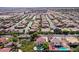 Expansive aerial view of a residential community with well-maintained homes, pools, and landscaping in a desert-like environment at 3396 Montessouri St, Las Vegas, NV 89117