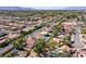 Expansive aerial view of a suburban neighborhood, showing houses with pools and green landscaping at 3396 Montessouri St, Las Vegas, NV 89117