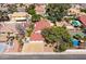 An aerial view displaying a home with a spacious driveway and backyard, and a pool at 3396 Montessouri St, Las Vegas, NV 89117