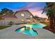 Entertain in this backyard oasis featuring a large pool, mature palms and outdoor dining at 3396 Montessouri St, Las Vegas, NV 89117