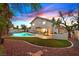 Beautiful backyard with a sparkling pool, lush landscaping, and spacious patio area at 3396 Montessouri St, Las Vegas, NV 89117