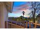 Balcony view showcasing neighborhood, mountains, palm trees, and scenic sunset skies at 3396 Montessouri St, Las Vegas, NV 89117