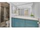 Modern bathroom features stylish blue vanity with marble countertop and shower with tiled walls at 3396 Montessouri St, Las Vegas, NV 89117