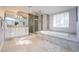Luxurious bathroom featuring a soaking tub, walk-in shower, and double vanity with marble accents at 3396 Montessouri St, Las Vegas, NV 89117