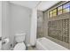 Clean bathroom with a shower-tub combo, updated fixtures, and tiled accent wall at 3396 Montessouri St, Las Vegas, NV 89117