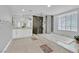 A spacious bathroom offers a walk-in glass shower, a tub, and a dual sink vanity with marble countertop at 3396 Montessouri St, Las Vegas, NV 89117