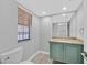 Bathroom features a light-colored vanity and tile flooring, with a modern sink and mirror at 3396 Montessouri St, Las Vegas, NV 89117