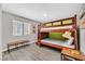 Cozy bedroom with bunk beds, bench, and wood-look floors, creating a comfortable space at 3396 Montessouri St, Las Vegas, NV 89117