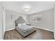 Stylish bedroom featuring a plush bed with a tufted headboard and wood laminate flooring at 3396 Montessouri St, Las Vegas, NV 89117