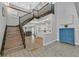 Bright open foyer with staircase, built-in shelving, wood look tile flooring, and contemporary decor at 3396 Montessouri St, Las Vegas, NV 89117