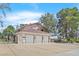 Spacious home with a three-car garage, large driveway, mature trees, and secure gate at 3396 Montessouri St, Las Vegas, NV 89117