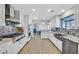 Updated kitchen features stainless appliances, white cabinets, granite counters, and a breakfast bar at 3396 Montessouri St, Las Vegas, NV 89117