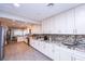 Bright kitchen features granite counters, mosaic tile backsplash, stainless steel appliances, and wood look tile flooring at 3396 Montessouri St, Las Vegas, NV 89117