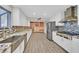 Modern kitchen with stainless steel appliances, white cabinets, granite counters, and tile backsplash at 3396 Montessouri St, Las Vegas, NV 89117