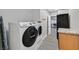 Well-equipped laundry room featuring modern washer and dryer, with stone countertops at 3396 Montessouri St, Las Vegas, NV 89117