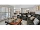 Open-concept living room with a leather sofa and view of the dining area and kitchen at 3396 Montessouri St, Las Vegas, NV 89117