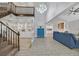 Bright and airy living room with a staircase, chandelier, and built-in shelving at 3396 Montessouri St, Las Vegas, NV 89117