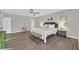 Spacious main bedroom with wood floors, large bed, and neutral decor with ceiling fan at 3396 Montessouri St, Las Vegas, NV 89117