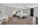 A spacious main bedroom boasts wood floors, neutral paint, ceiling fan, desk, bench and outdoor access at 3396 Montessouri St, Las Vegas, NV 89117