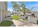 Spacious outdoor kitchen, synthetic grass, and stone pathway in a well maintained backyard for entertaining at 3396 Montessouri St, Las Vegas, NV 89117