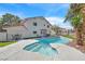 Stunning backyard pool and spa, perfect for relaxation and entertaining with lush, green landscaping and outdoor seating at 3396 Montessouri St, Las Vegas, NV 89117