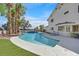 Lovely pool with a serene spa, surrounded by lush synthetic grass and the home’s well-maintained exterior at 3396 Montessouri St, Las Vegas, NV 89117