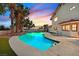 Stunning backyard pool with waterfall feature, mature landscaping, and ample deck space at 3396 Montessouri St, Las Vegas, NV 89117