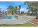 Gorgeous backyard with an in-ground pool featuring a spa and steps and lovely landscaping, surrounded by tall palm trees at 3396 Montessouri St, Las Vegas, NV 89117