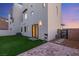 Modern home featuring a small backyard with artificial grass and a brick patio, perfect for outdoor relaxation at 350 Solitude Peak Ln, Henderson, NV 89012