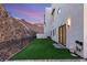 The home features an artificial turf backyard with a hillside view at 350 Solitude Peak Ln, Henderson, NV 89012