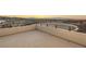 Generous balcony with panoramic views of the cityscape and mountain range at sunset at 350 Solitude Peak Ln, Henderson, NV 89012