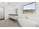 Serene bathroom with a freestanding tub, double vanities, and a scenic window view, perfect for relaxation at 350 Solitude Peak Ln, Henderson, NV 89012