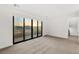 Bright bedroom showcasing neutral carpeting and sliding glass doors providing access to scenic outdoor views at 350 Solitude Peak Ln, Henderson, NV 89012