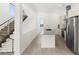 Modern kitchen with stainless steel appliances, granite countertops, and a staircase at 350 Solitude Peak Ln, Henderson, NV 89012