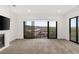 Bright living room with a fireplace and large sliding glass doors offering scenic views at 350 Solitude Peak Ln, Henderson, NV 89012