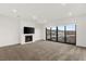 Open living space boasts a modern fireplace, neutral carpet, and sliding doors to the outside at 350 Solitude Peak Ln, Henderson, NV 89012