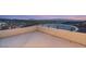 Spacious rooftop deck with black metal railing, offering panoramic views of the surrounding landscape at 350 Solitude Peak Ln, Henderson, NV 89012