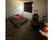 Modest bedroom with tiled flooring, dark curtains, a bed, and a desk with an office chair at 3585 Arville St # 401A, Las Vegas, NV 89103