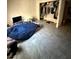 Bedroom featuring grey tile flooring, and an open closet filled with clothing, and a tv at 3585 Arville St # 401A, Las Vegas, NV 89103