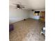 Spacious living room with neutral tile flooring, ceiling fans, and an open layout leading to the kitchen at 3585 Arville St # 401A, Las Vegas, NV 89103