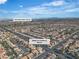 Aerial view of a residential area with homes, streets, and Durango Golf Club in the distance at 3604 N Campbell Rd, Las Vegas, NV 89129