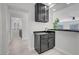 Convenient wet bar with modern fixtures, sink, and cabinetry, near a laundry room at 3604 N Campbell Rd, Las Vegas, NV 89129