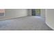 Spacious bedroom with neutral carpeting, light gray walls, a patio door, and a view of the balcony at 3604 N Campbell Rd, Las Vegas, NV 89129