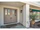 Elegant front doors with decorative glass panels, enhanced by a charming porch and desert landscaping at 3604 N Campbell Rd, Las Vegas, NV 89129