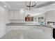 Spacious kitchen with granite countertops and open view to the backyard and pool at 3604 N Campbell Rd, Las Vegas, NV 89129