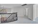 Bright landing with neutral carpeting, decorative railing, and views of the neighborhood through arched windows at 3604 N Campbell Rd, Las Vegas, NV 89129