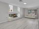 This living room features wood-look floors, a fireplace, and large windows at 3604 N Campbell Rd, Las Vegas, NV 89129