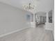 Open-concept living room showcasing light hardwood floors and an archway leading to the fireplace and seating area at 3604 N Campbell Rd, Las Vegas, NV 89129