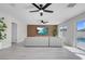 Open concept living room boasts recessed lights, ceiling fans, a view of the pool and wood accent wall at 3604 N Campbell Rd, Las Vegas, NV 89129